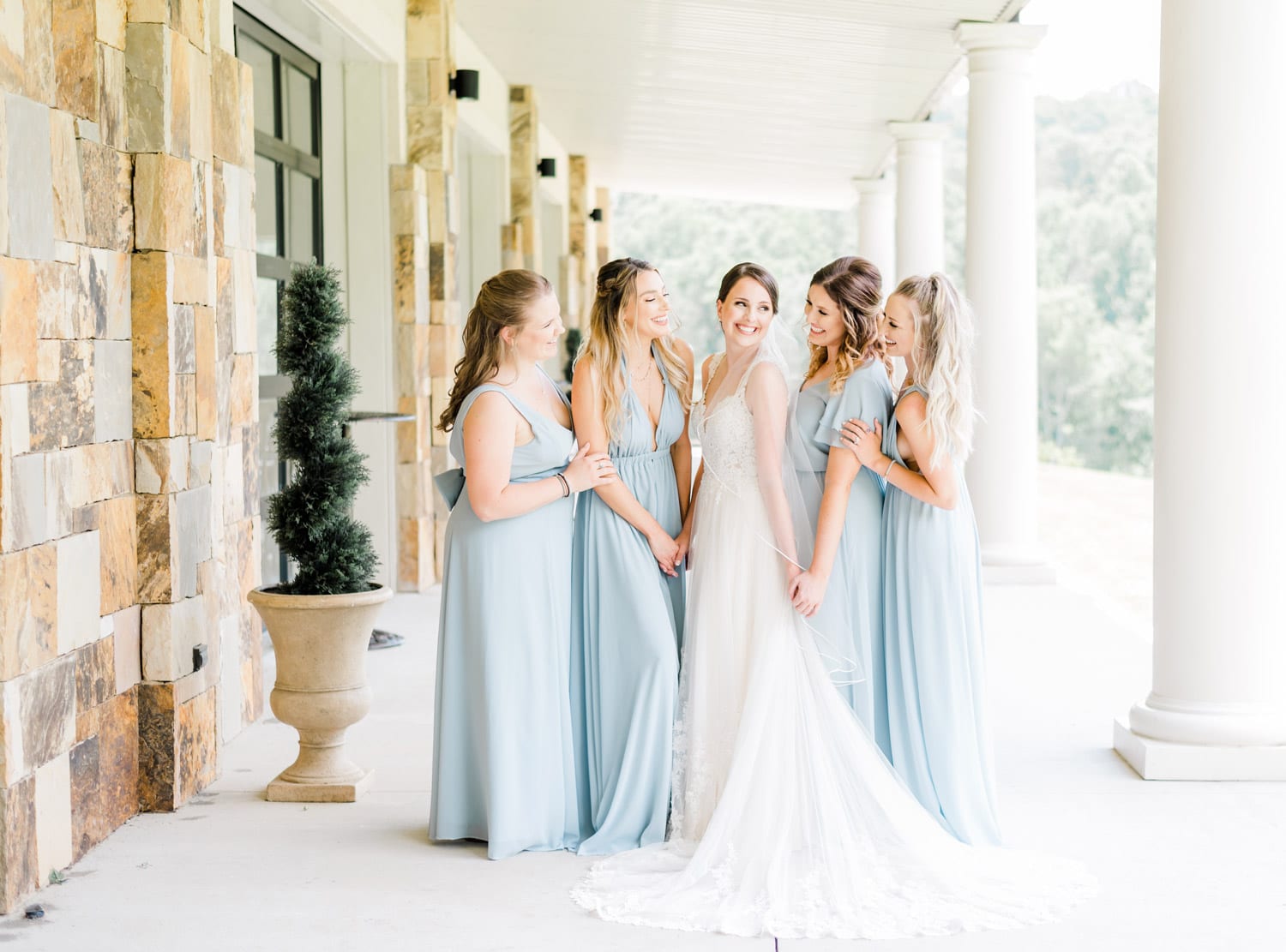 Bride and bridesmaids standing on porch