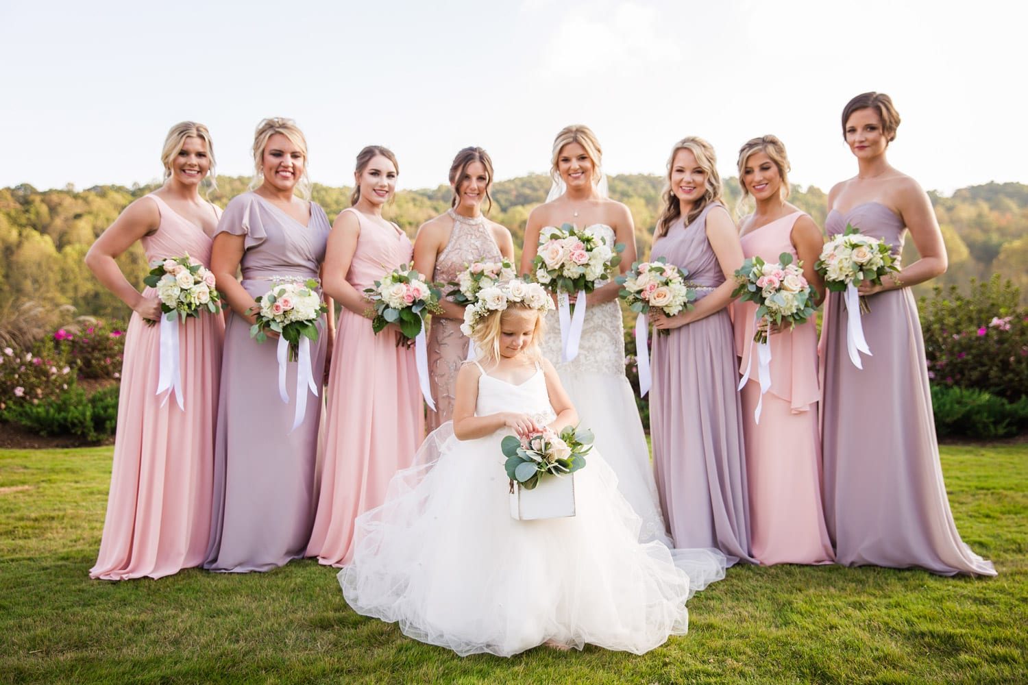 Flower girl outside with bride and bridesmaids