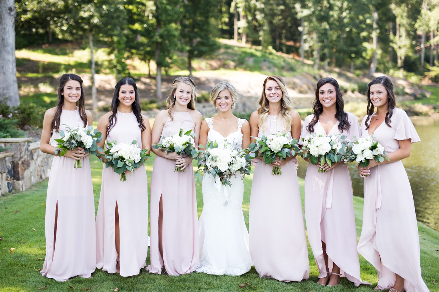 Bride and bridesmaids holding flowers outside