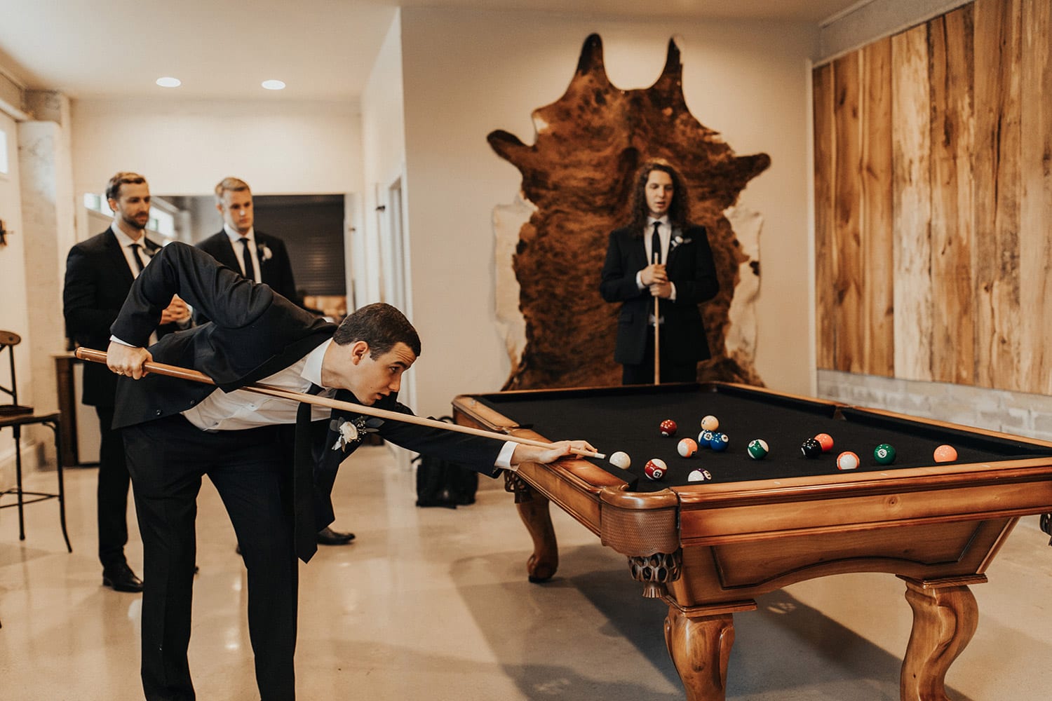Groomsmen playing billiards