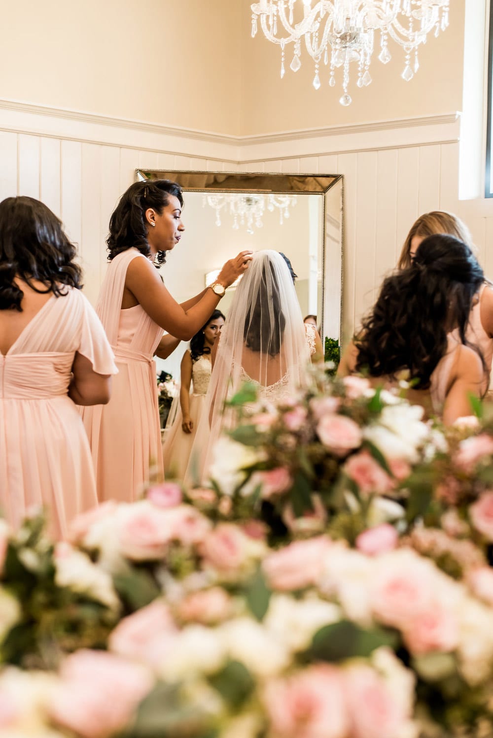 Bride getting ready in front of mirror
