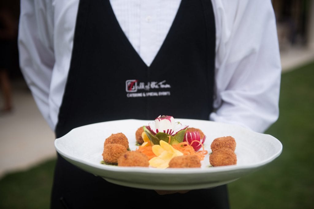 Waiter holds tray of appetizers