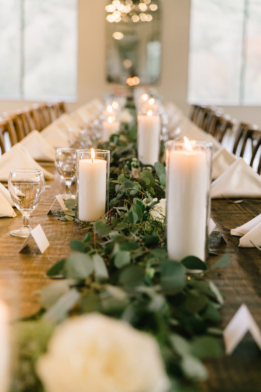 Estate table with candles and greenery