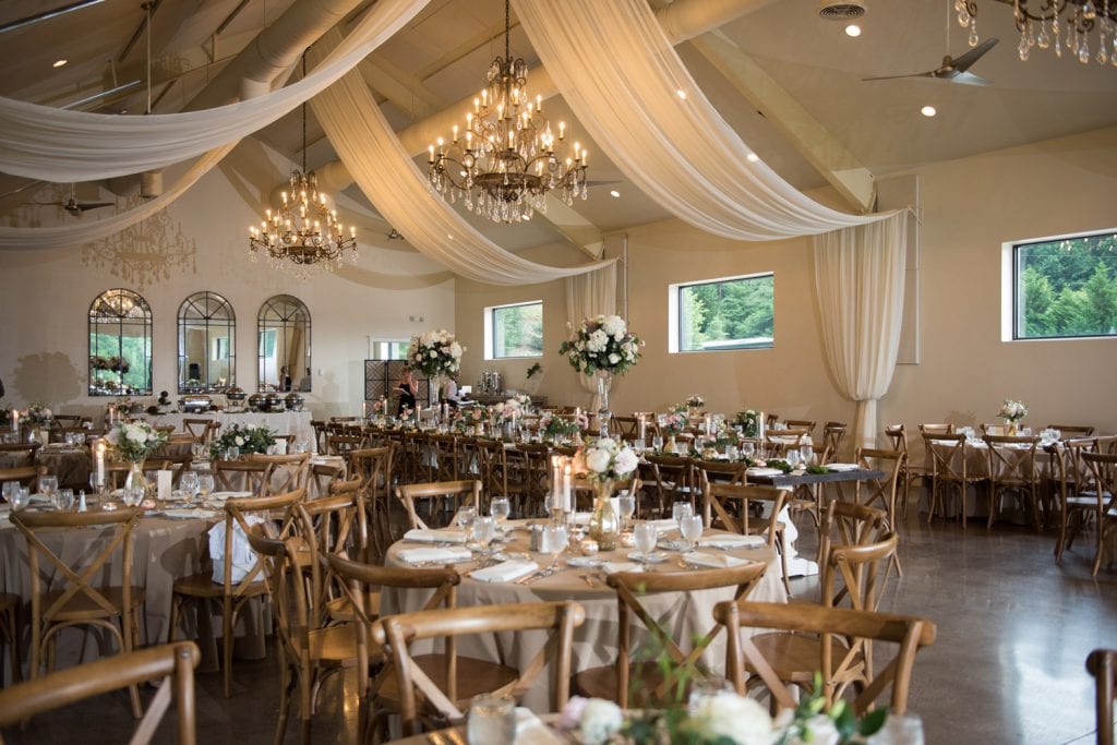 Wide view of decorated reception hall with chandeliers