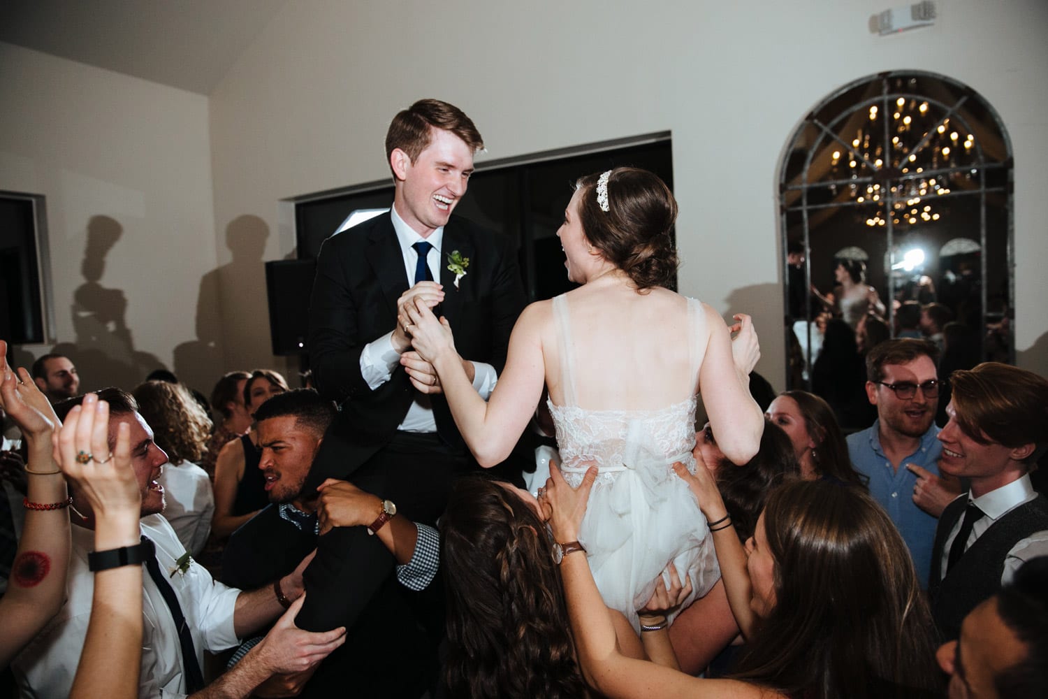 Bride and groom are carried on dance floor