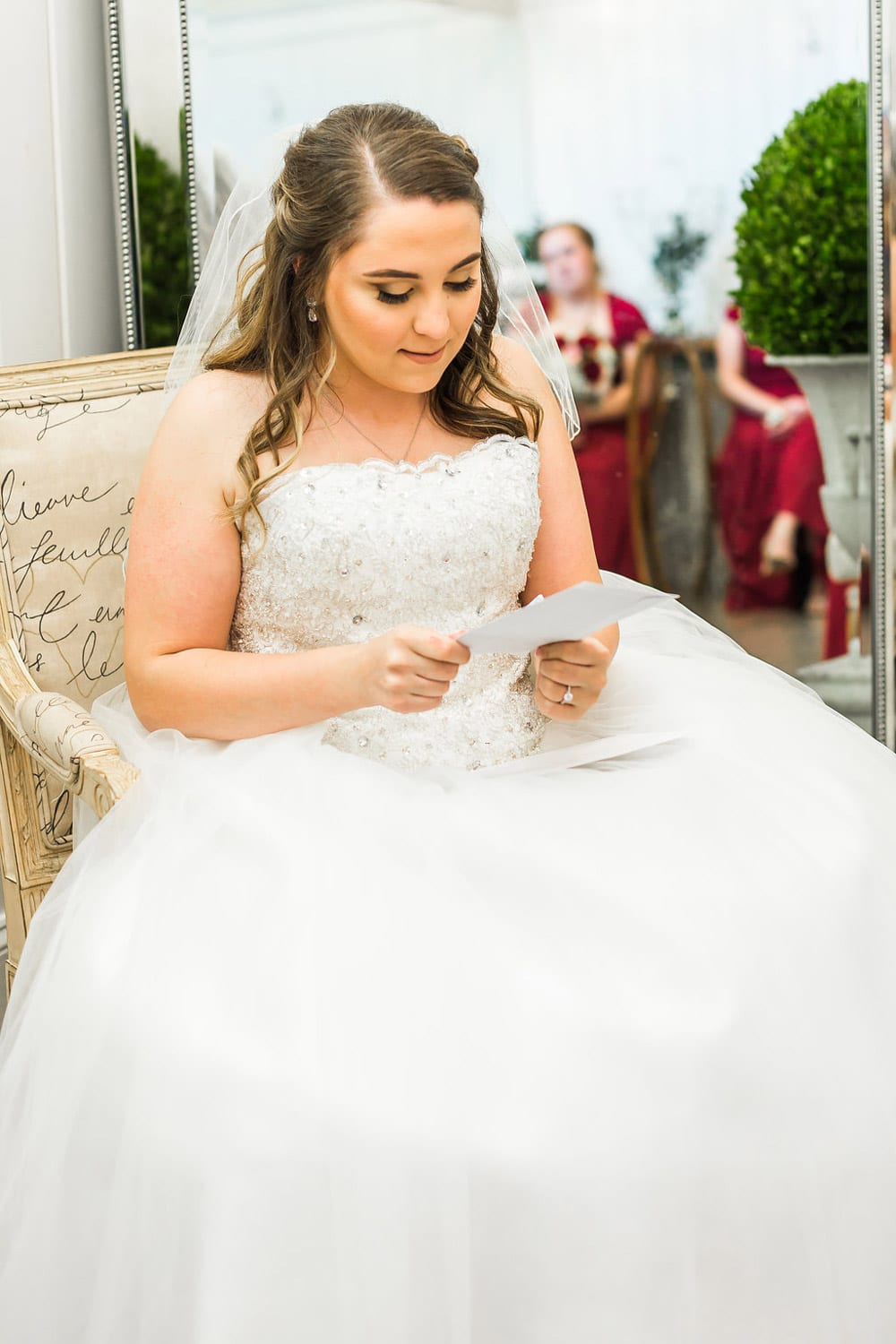 Bride reads letter in bridal room