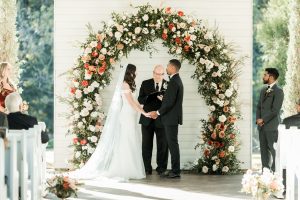 Bride and groom hold hands in wedding chapel as vows are exchanged at a north Georgia wedding venue